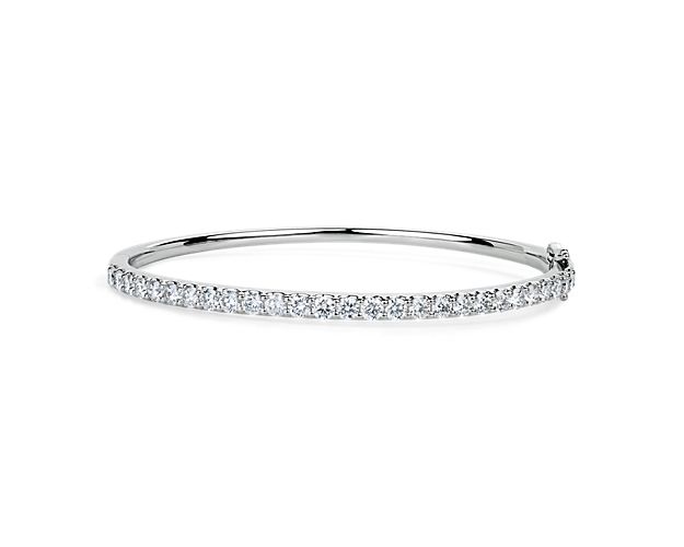 Add gorgeous gleam to your wrist with this round bangle bracelet crafted from bright 14k white gold. Brilliant lab-grown diamonds encircle the bracelet, adding sparkling luxury.