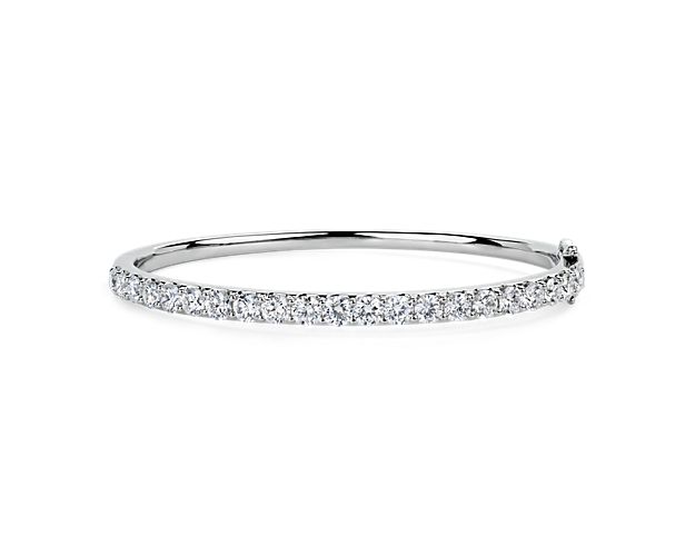 Add gorgeous gleam to your wrist with this round bangle bracelet crafted from bright 14k white gold. Brilliant lab-grown diamonds encircle the bracelet, adding sparkling luxury.