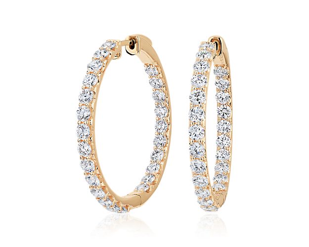 Stunning lab grown diamonds sparkle along the front edges of these elegant eternity hoop earrings. The cool gleam of the 14k white gold design beautifully complements the shimmer of the stones.