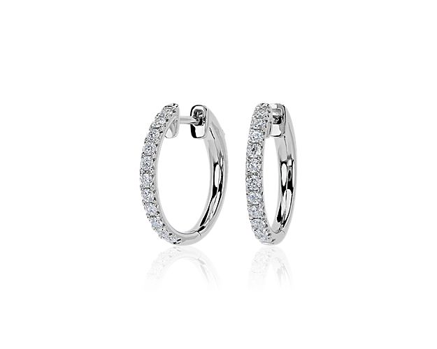 Lend elegant sparkle to your look with these stunning hoop earrings featuring French pavé-set diamonds shimmering along the front-facing edges. Lustrous 14k white gold completes the look with luxurious style.