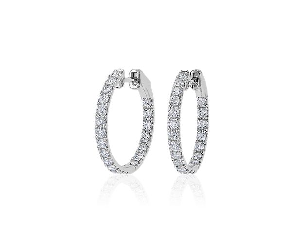 Timelessly elegant, these hoop earrings sparkle with French pavé-set diamonds shimmering along the front-facing edges. The eternity hoops are crafted in beautifully gleaming 14k white gold that promises lasting luxurious quality.