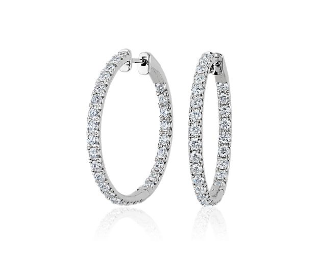 Bring a touch of sparkle to your style with these eternity hoop earrings that shimmer with diamonds sparkling in a French pavé setting in the front-facing edges. They are designed in 14k white gold that promises an enduring cool lustre.
