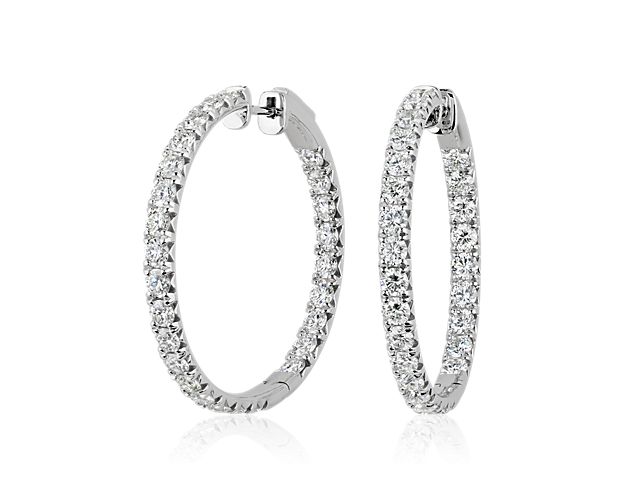 Add the finishing touch to your look with  these elegant eternity hoop earrings crafted in gleaming 14k white gold. The front-facing edges sparkle with French pavé-set diamonds for a dazzling effect.