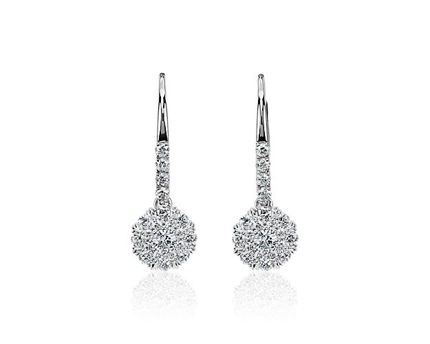 Shimmer under the light as you wear these stunning drop earrings featuring a gorgeous centre diamond nestled in a dramatically sparkling double halo of diamonds. They are designed in 14k white gold to ensure enduring quality.