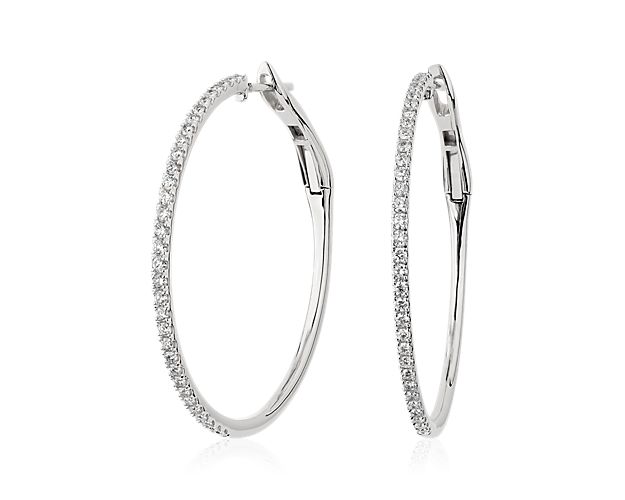 Sparkle through the room when you wear these elegant skinny hoop earrings that sparkle with brilliant diamonds along the front-facing edge. The soft lustre of the 14k white gold design complements the stones.