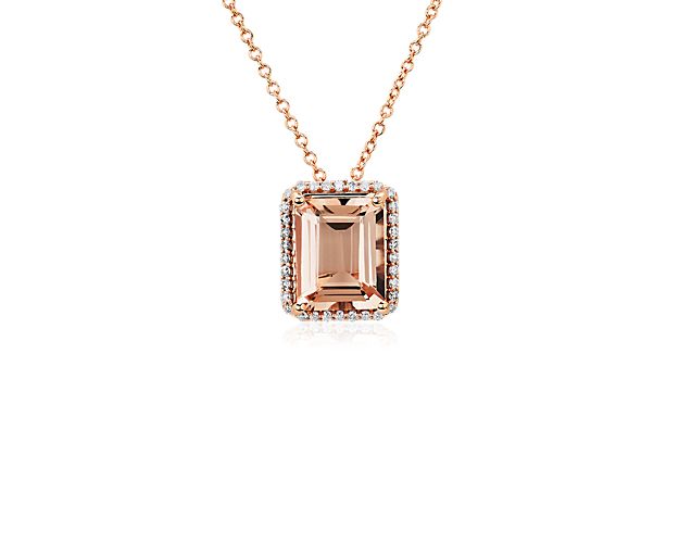 This romantic pendant is defined by an elegant emerald-cut morganite stone at its heart, surrounded by a shimmering halo. The warm gleam of the 14k rose gold complements the pink hues of the stone beautifully.