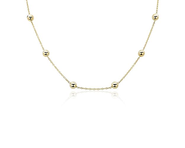 Gleaming beads shimmer at evenly spaced intervals along this elegant 18'' necklace. The warm gleam of the 14k yellow gold gives it a timelessly luxurious look.