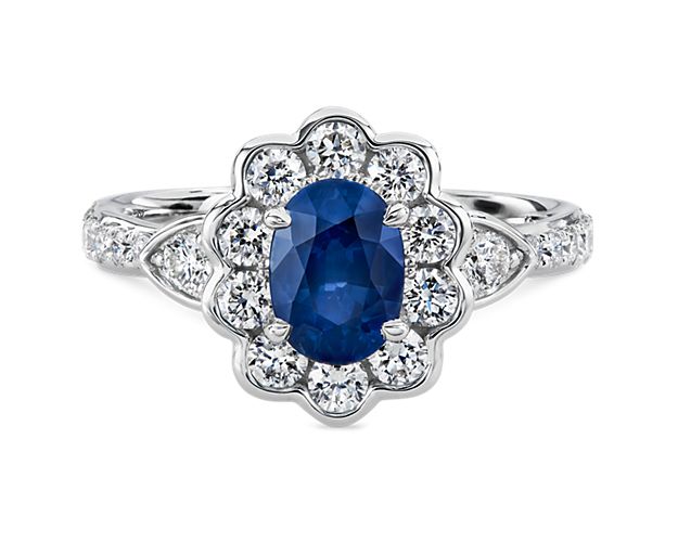 Flower-shaped ring with a center oval sapphire and accent diamonds