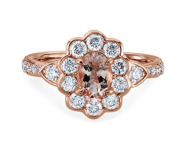 This romantic ring features an oval-cut morganite stone, drawing the eye to its beautiful pink hue. Petal-styled accent diamonds surround it, and the warm lustre of the 14k rose gold design completes the effect.