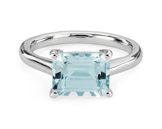 Bring brilliant sparkle to your look when you wear this mesmerizing ring featuring a single baguette-cut aquamarine shimmering in a stately east-west setting. It is designed in 14k white gold that promises an enduring lustre and quality.