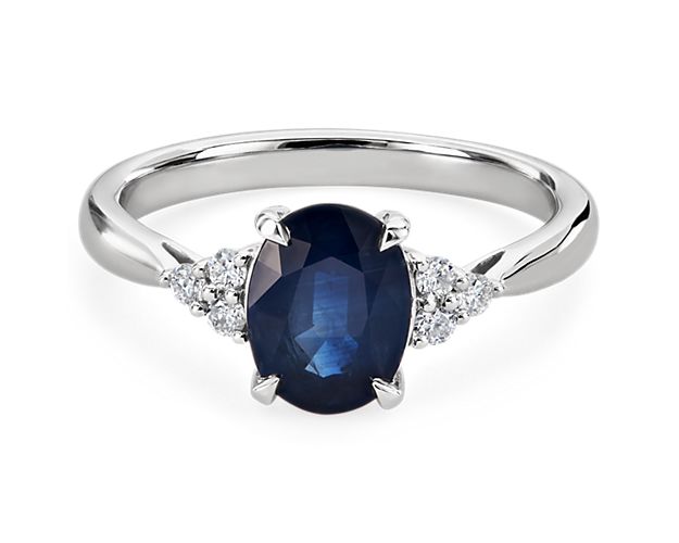 Take their breath away with this stunning ring featuring a gorgeous oval-cut sapphire at its centre, flanked by a trio of accent diamond on either side. The 14k white gold setting completes the look with luxurious quality.