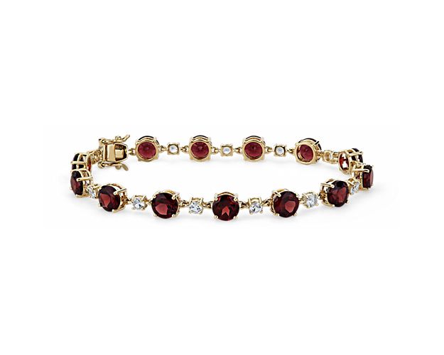 Gorgeously deep red garnets alternate with sparkling white sapphires in an endless loop along this elegant bracelet. The warm gleam of the 14k yellow gold design complements the rich hues of the stones.