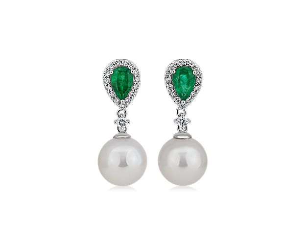 Step out in sophisticated style in these drop earrings each defined by a gleaming Akoya pearl, and a brilliant green emerald set into the post. Bright accent diamonds adds dramatic sparkle.