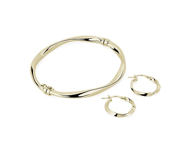 Look polished and put together in this gorgeous gold bangle and matching hoop earring set, featuring twisted details that make it perfect for any occasion.