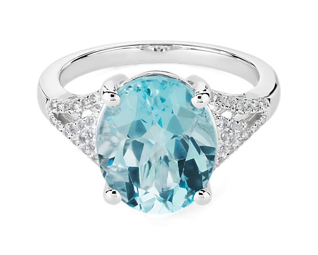 Take their breath away with this statement cocktail ring featuring a stunning oval-cut sky blue topaz stone nestled at its heart. It is set in 14k white gold that gleams beautifully to complement the cool tones of the centre stone.