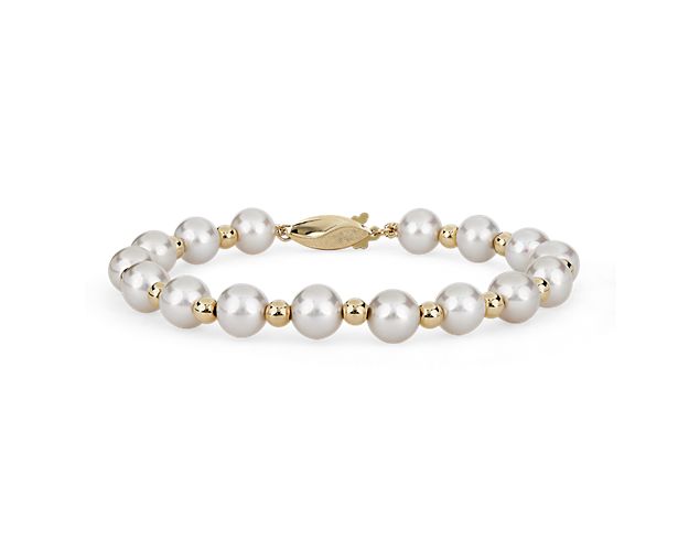 This timelessly sophisticated bracelet features freshwater beads spaced evenly along its 18'' length. The warm gleam of the 14k yellow gold completes the elegantly luxurious effect.