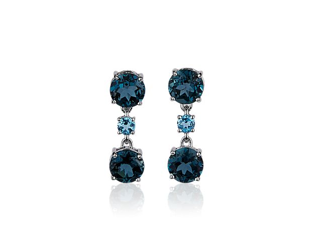 Shimmer as you catch the light when you wear these elegant drop earrings set with stunning Swiss blue topaz and London blue topaz stones for a mesmerizing effect. The cool lustre of the 14k white gold design beautifully complements the stones.