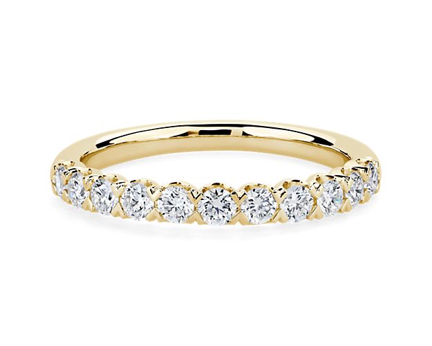 Elegantly romantic, this shimmering anniversary ring features a unique v-prong Pave setting holding the diamonds secure. The lustrous gleam of the 14k yellow gold design speaks of enduring luxury.