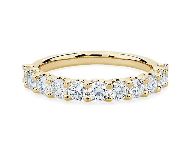 A classic beauty, this gorgeous 14k yellow gold diamond ring showcases a sparkling row of shared-prong set diamonds.