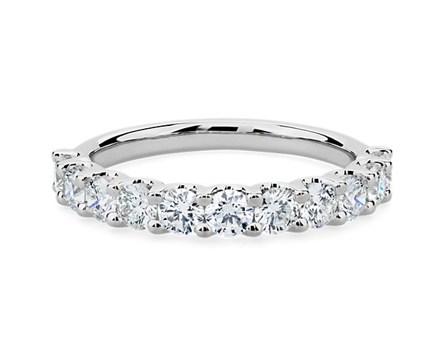 A classic beauty, this gorgeous platinum diamond ring showcases a sparkling row of shared-prong set diamonds.