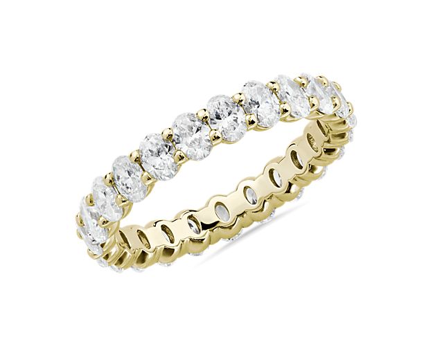 This lab grown diamond oval-cut eternity ring celebrates the brilliance of love, surrounded by the timeless shine of 14k yellow gold.