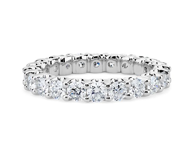 Elegant and brilliant, this diamond eternity ring features round diamonds set in a shared-prong and low-profile design of enduring platinum.