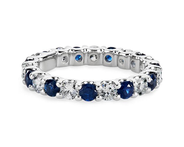 Brilliant and color-rich, this sapphire and diamond eternity ring features round sapphires and diamonds in a shared-prong design of 14k white gold.
