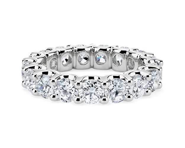 Encapsulate your endless love with this diamond eternity band. Crafted with platinum, the U-prongs of this ring expose the sides of the stones, delivering heightened shine from all angles.