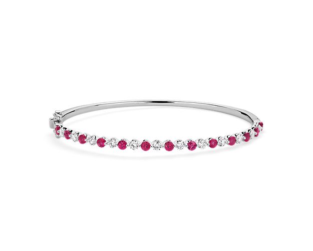 Layer it or wear it on its own, this 14k white gold bangle offers floating rubies and diamonds on a smooth circle with a side clasp for easy on and off.