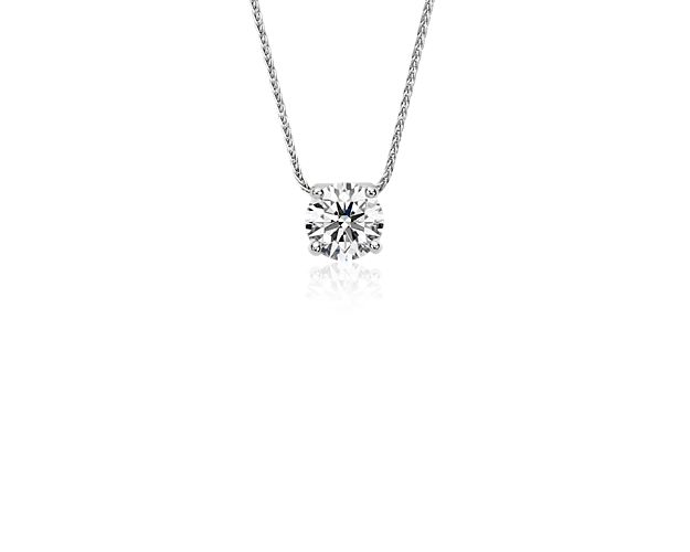 Classic elegance, this beautiful platinum pendant showcases a 1.25 carat brilliant Blue Nile Signature Ideal Cut round diamond set in a contemporary floating bail design with a luxurious adjustable length chain. Versatile style to celebrate everyday or the most special of occasions. This pendant is accompanied by a GCAL report.