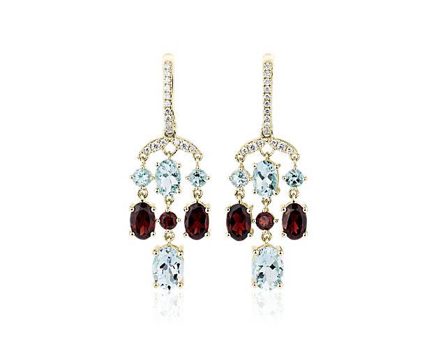 Stand out in the crowd when you wear these breath-taking chandelier earrings set with gorgeously dangling garnet and aquamarine stones. The intricate 14k yellow gold design gives them enduring quality and lustre.
