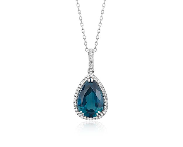 This classic pear-shaped London blue topaz drop pendant is a sophisticated style that can be dressed up or down depending on the occasion. A halo of 47 round white topaz gemstones adds extra sparkle.