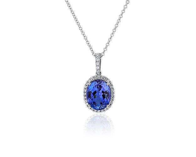 A mesmerizing deep blue oval-cut tanzanite stone glitters at the centre of this timelessly elegant pendant. The white gold design features a delicate diamond halo to accentuate the main stone.