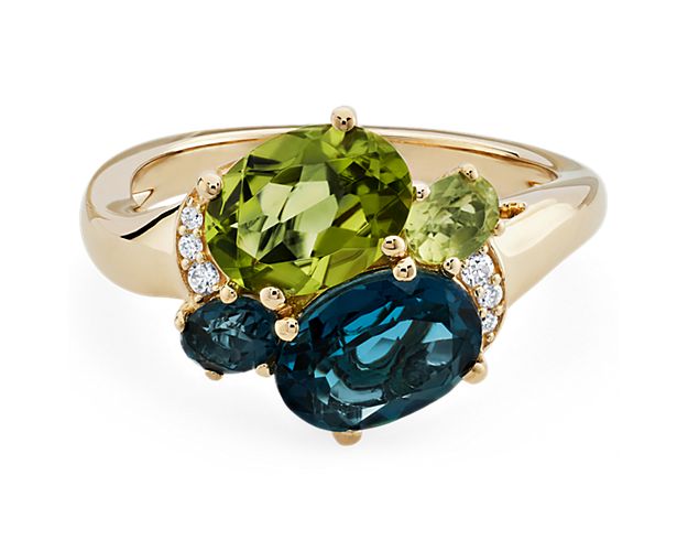 This stunning cocktail ring will take your breath away. A gorgeous combination of London Blue Topaz and Peridot gemstones nestled in 14k yellow gold will light up any outfit. This piece is finished with diamond accents, creating an extra sparkle and luxurious feel