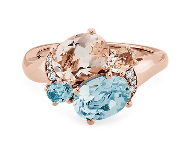 Expertly crafted from luxurious 14k rose gold, this ring features an exquisite Morganite gemstone as well as a mesmerizing Aquamarine gemstone. To add even more opulence, this ring also features delicate diamond accents that wrap around, glistening in the light with every movement