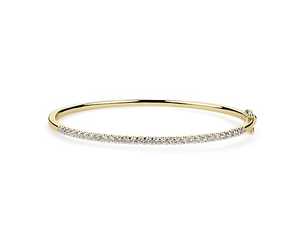 Add a dash of sparkle to your wrist with this stunning bangle crafted in gleaming 14k yellow gold. The front edge is lined with a shimmering 1 ct. tw. in gorgeously brilliant diamonds.