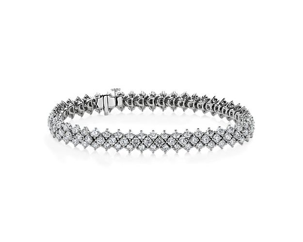 Multiple rows of diamonds shimmer in dramatic style along the length of this bracelet, promising breath-taking brilliance. It is designed in coolly lustrous 14k white gold to complement the stones.