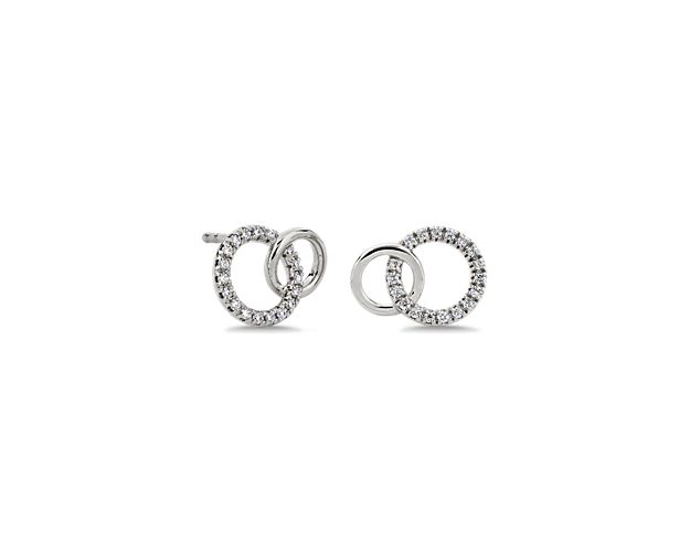 Catch the light as you turn your head in these delicately shimmering earrings featuring one diamond-detailed circle and one plain circle entwined in a graceful design. The 14k white gold design promises a rich lustre that lasts.