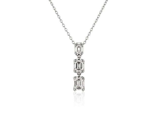 Sparkling emerald-cut diamonds in graduating sizes dangle gracefully in this simply elegant drop pendant necklace. The setting and chain are crafted from 14k white gold for enduring lustre and quality. Pair it with the matching earrings for a gorgeously coordinated effect.