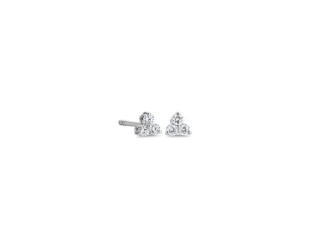 Catch the light as you wear these elegant stud earrings, each featuring a clustered trio of diamonds. The cool lustre of the 14k white gold design provides the perfect complement to the stones’ sparkle.
