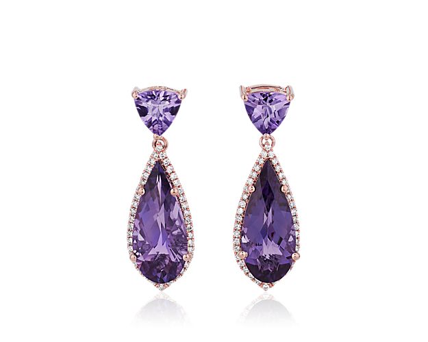 Go for dramatic grace as you wear these stunning drop earrings, each defined by a trillion-cut and pear-cut amethyst. The pear-cut stone is accentuated with a shimmering diamond halo, and the intricately detailed 14k rose gold setting adds to the elegance.