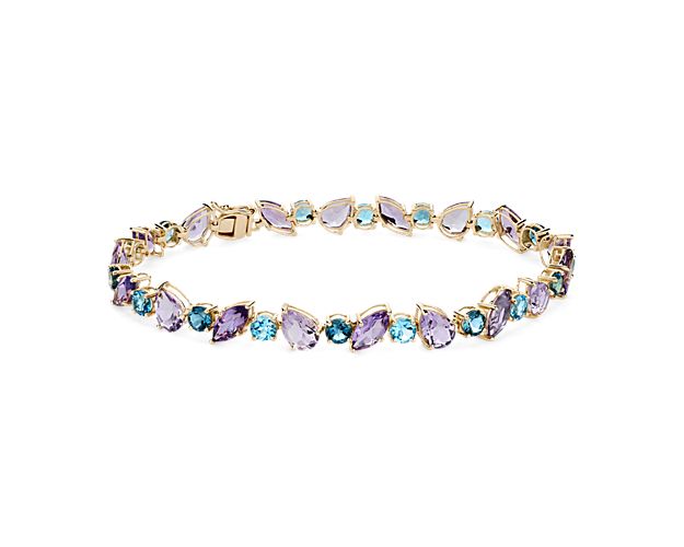 Amethyst and blue topaz stones shimmer in an array of cuts along the length of this unique bracelet. The warmth of the 14k yellow gold design beautifully contrasts with the rich hues of the stones.