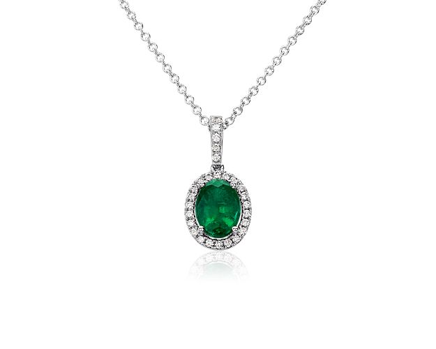 Opt for stunning elegance with this pendant necklace featuring a vibrant oval-cut emerald featuring a halo of micropavÃ© diamonds, with delicate diamonds trailing up the bale. The cool gleam of the 14k white gold design completes it in luxurious style.