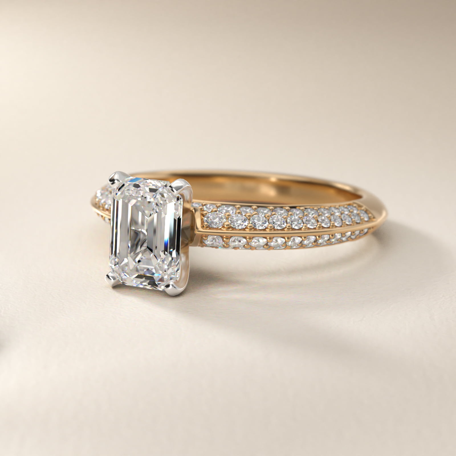 Emerald cut diamond engagement ring yellow gold pavé band packshot on white