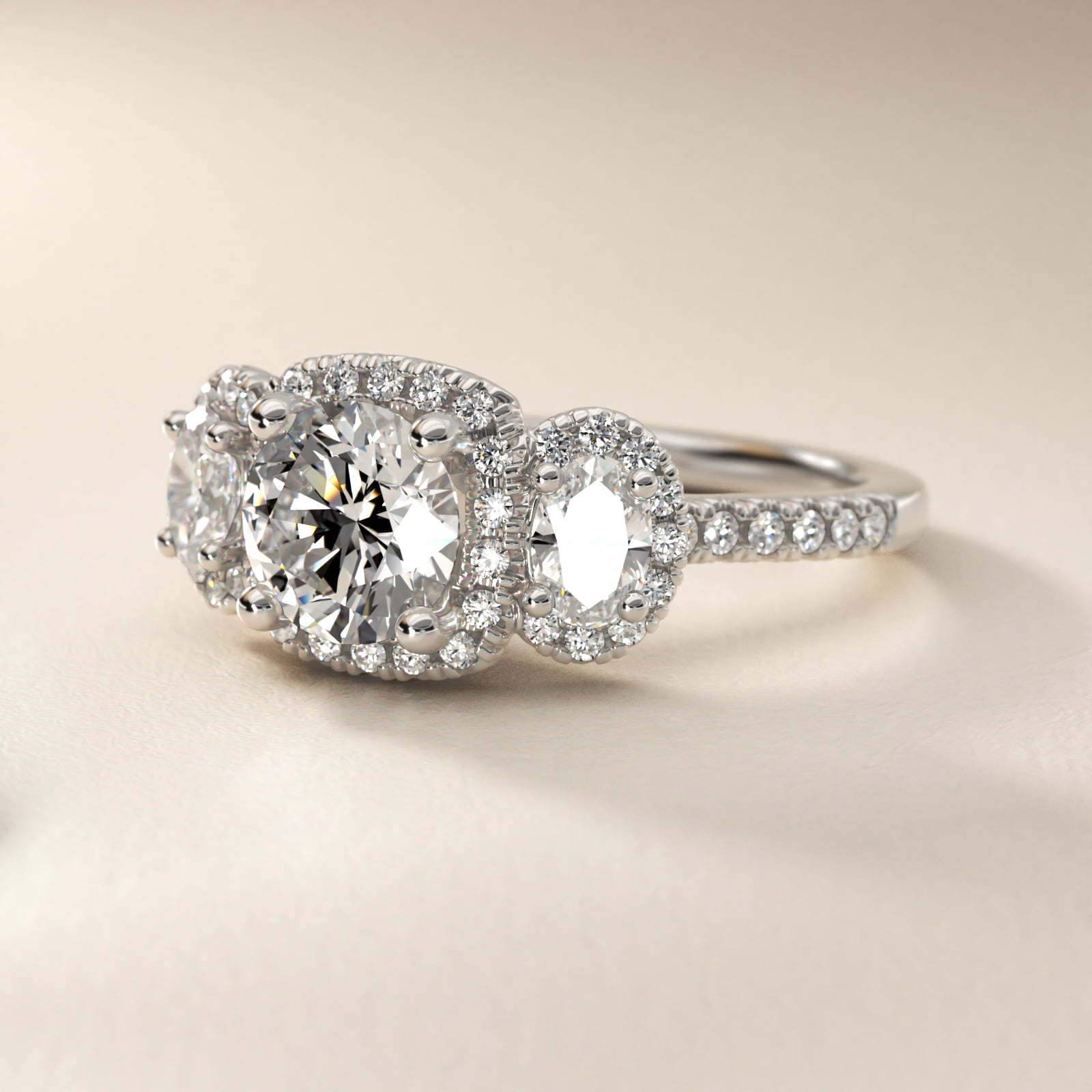 Three-Stone Oval Halo Diamond Engagement Ring in Platinum