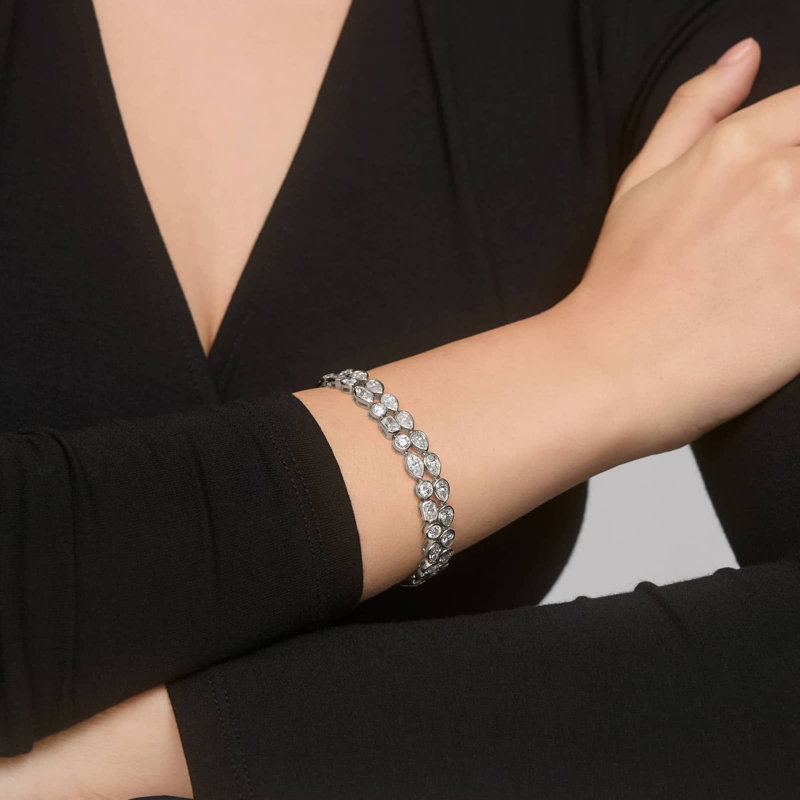 East-West Bezel Tennis Bracelet With 8 CTW Pear Shaped Diamonds in Platinum