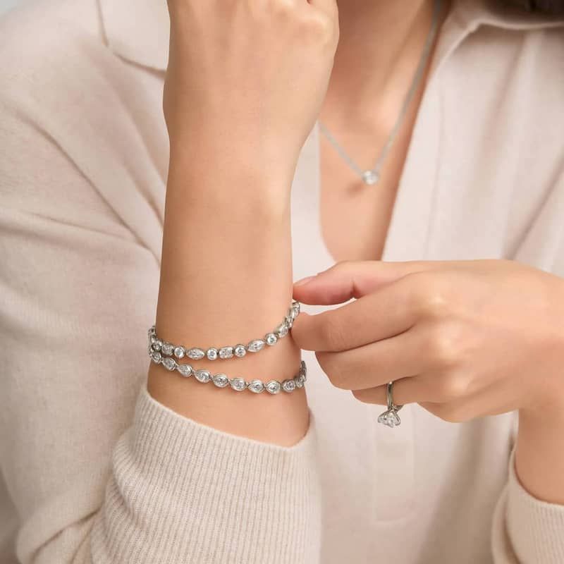 East-West Bezel Tennis Bracelet With 10 CTW Pear Shaped Diamonds in 14K White Gold