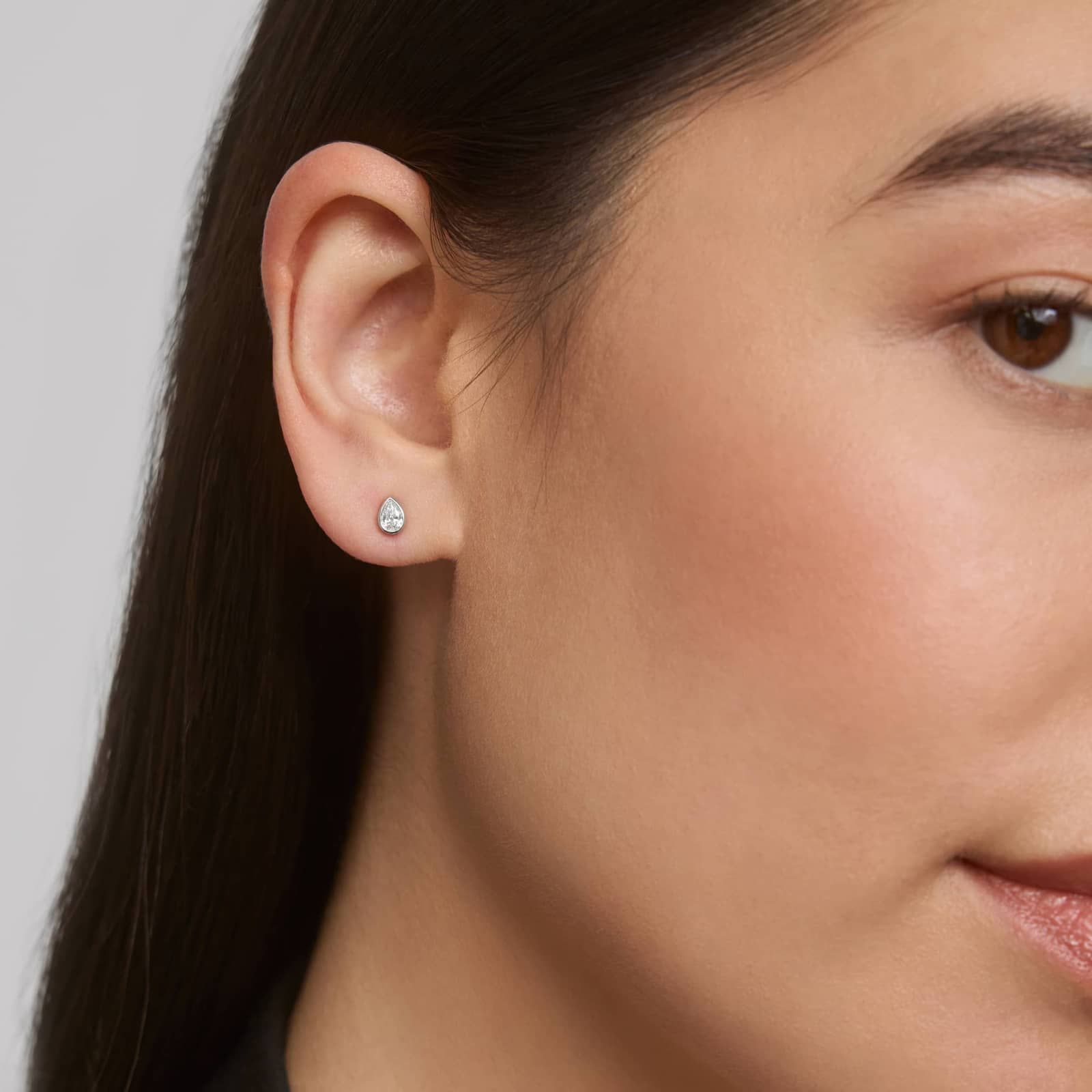 Bezel Diamond Stud Earrings With 0.25 CTW Pear Shaped Diamonds in Platinum