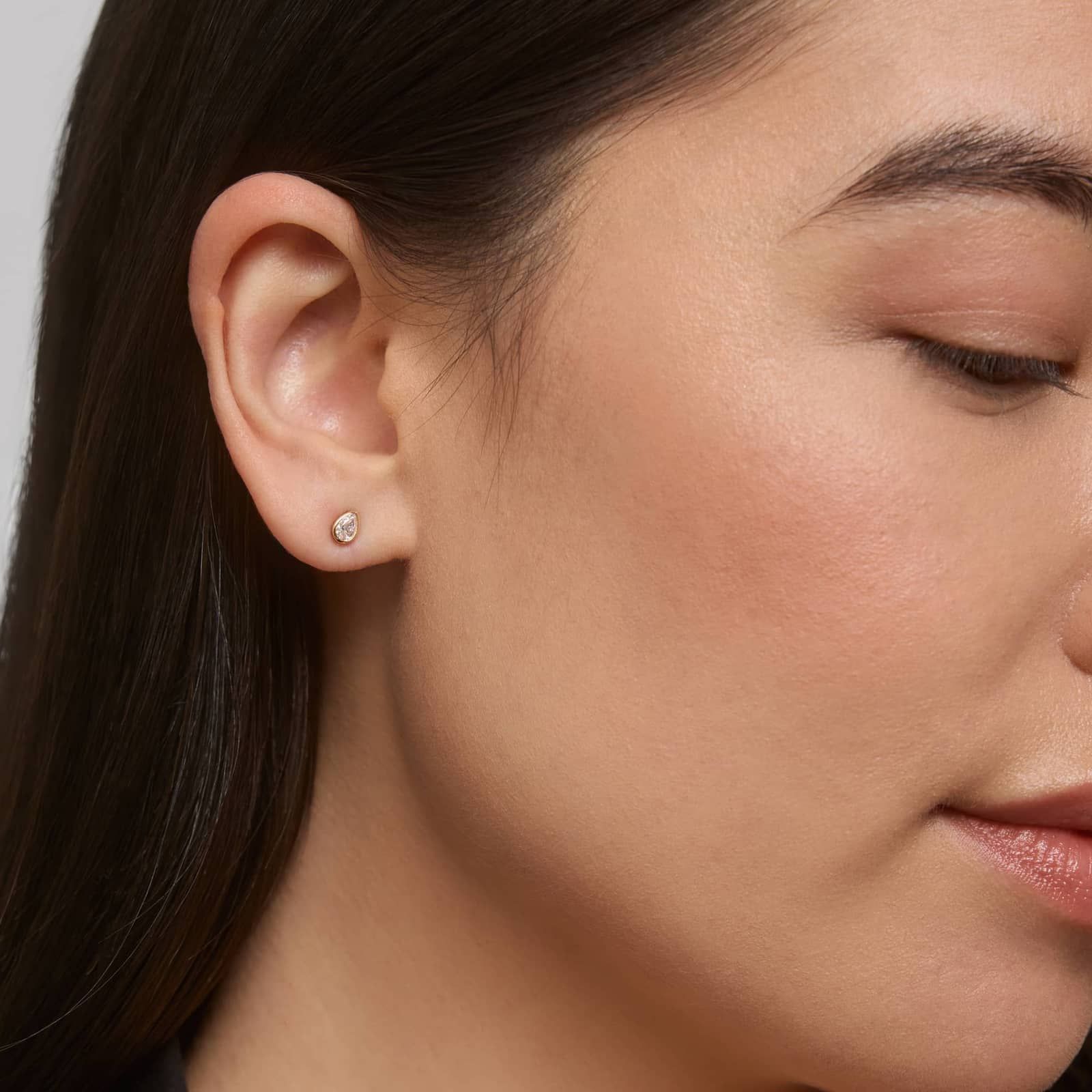 Bezel Diamond Stud Earrings With 0.25 CTW Pear Shaped Diamonds in 14K Yellow Gold