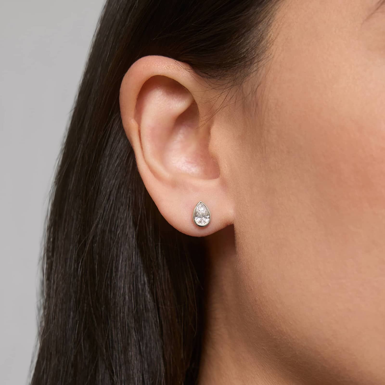 Bezel Diamond Stud Earrings With 1 CTW Pear Shaped Diamonds in Platinum